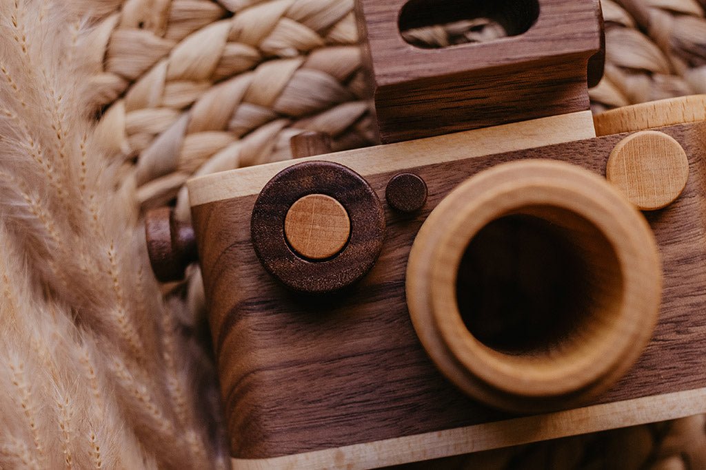 Close-up of the wooden toy camera's walnut body and kaleidoscope lens