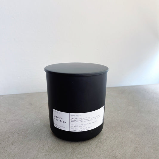 Tobacco and Saffron wooden wick candle in a matte black jar from Maison Creole Compass