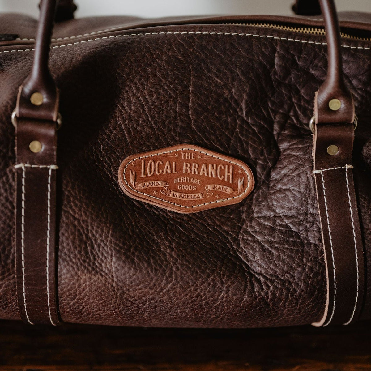 Detail of the Nomad leather duffle in Chocolate