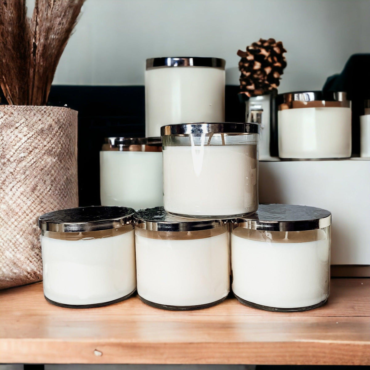 Large 3-wick soy candles in clear glass jars with silver lids from Maison Creole Compass