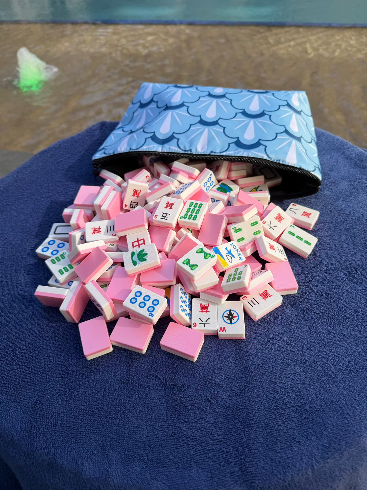 Pink Compass mahjong tiles spilling from their carry bag