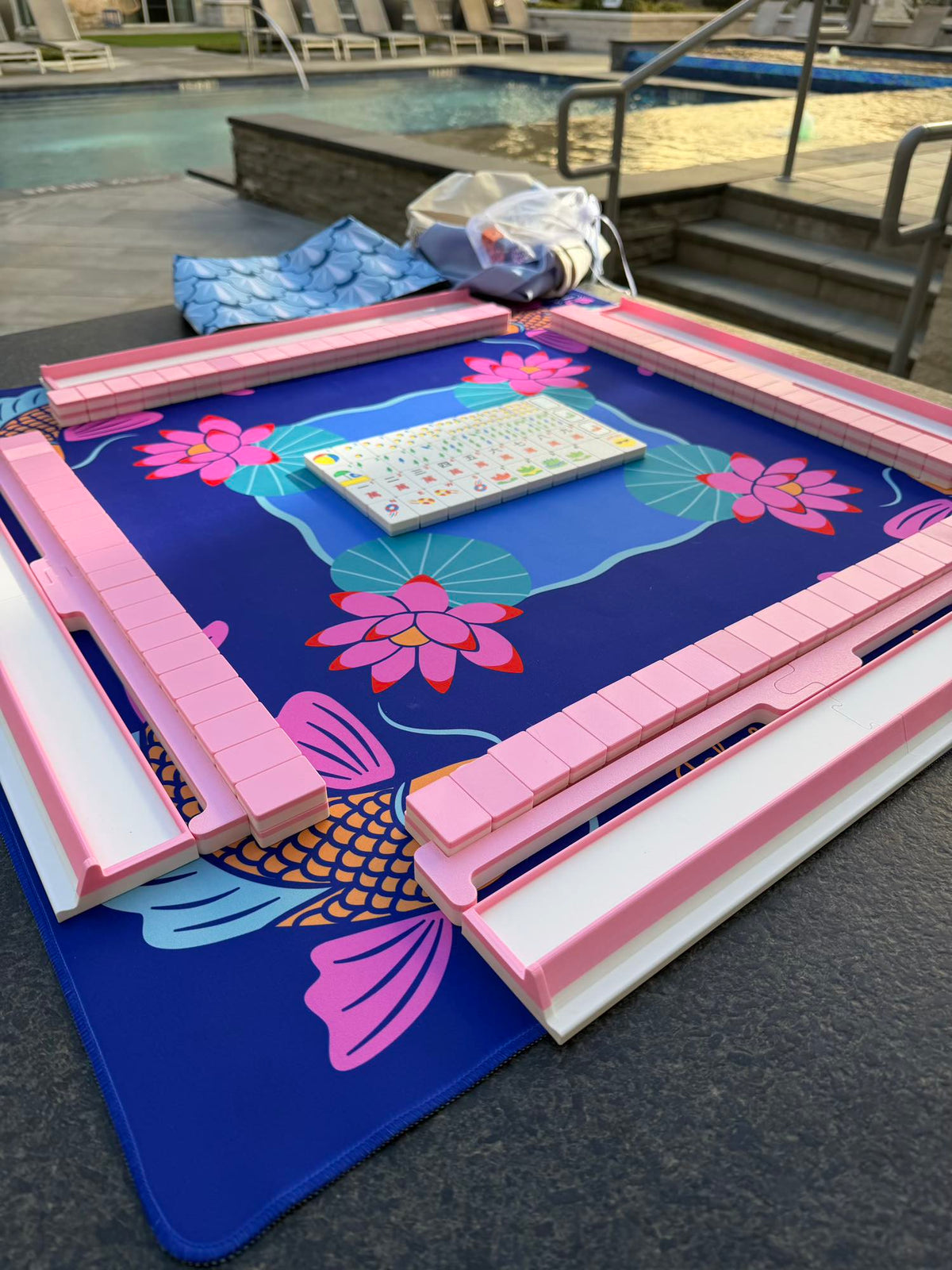 Pink Compass mahjong tiles on a playing mat