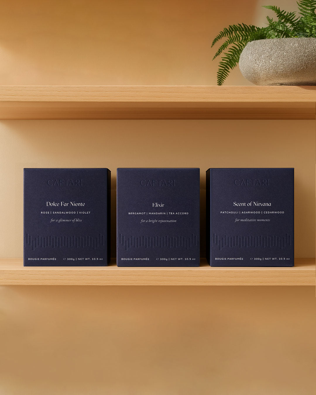 Signature Trio luxury candle gift set boxes on a shelf